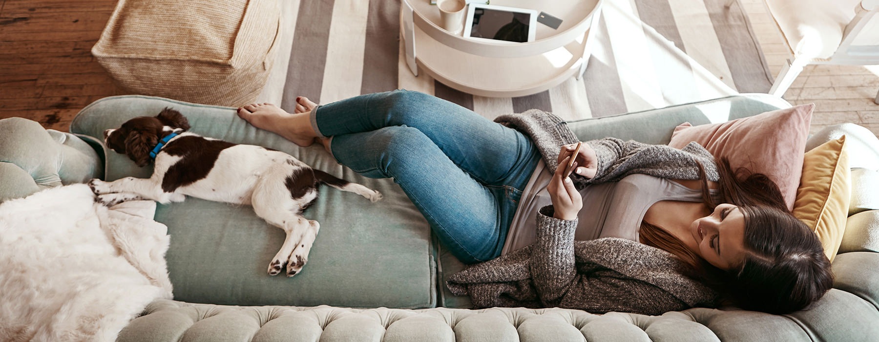 Woman and her dog laying on the couch